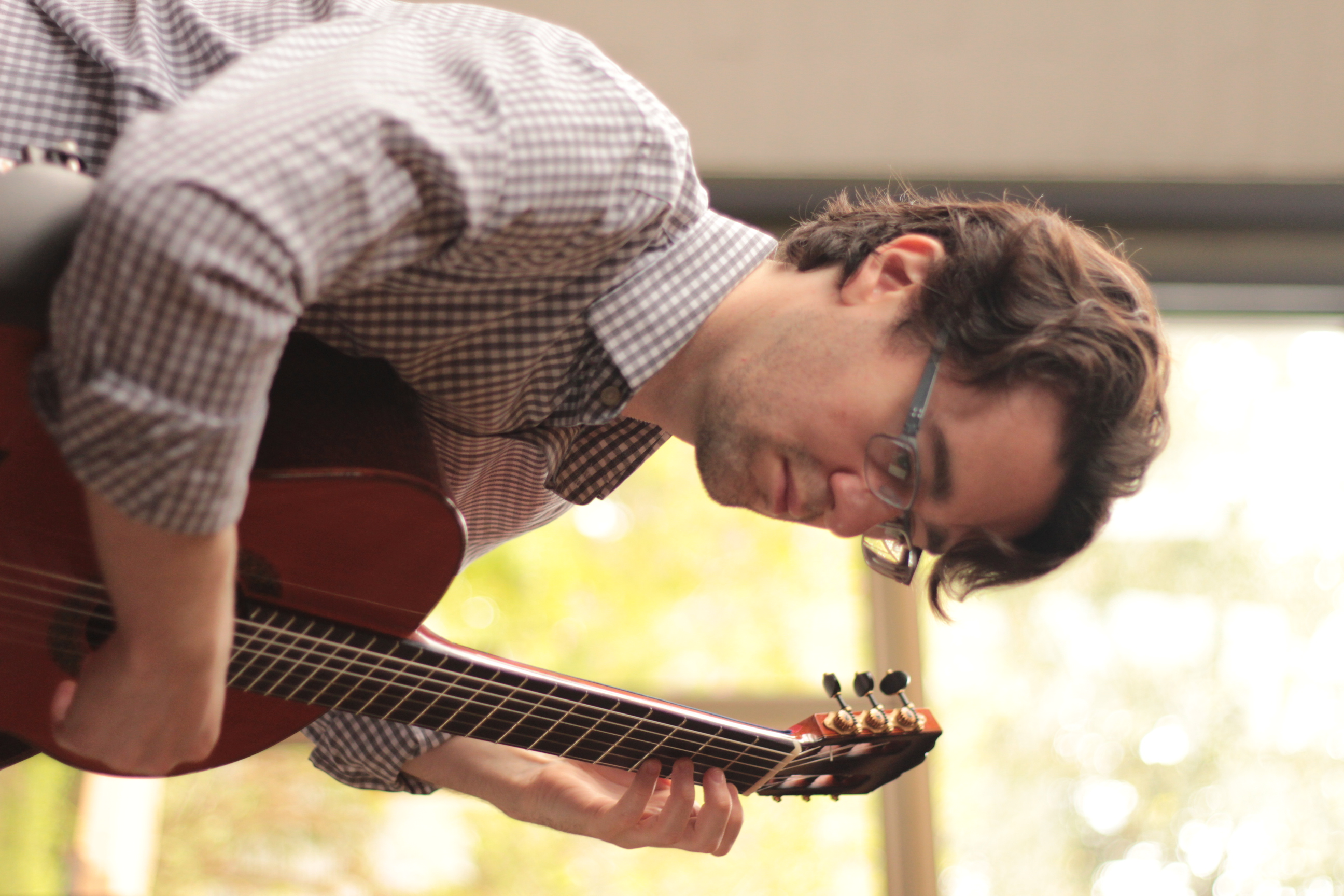A close portrait of Yuri Liberzon playing guitar during the Bach recording session.
